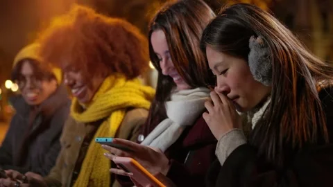 Hipster group of millennial friends using cell phones sitting together outdoor. Stock Footage 251236573