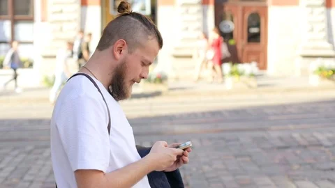 Hipster guy with a beard with a smartphone in his hand meets a girl. hipster Video stock 100731561