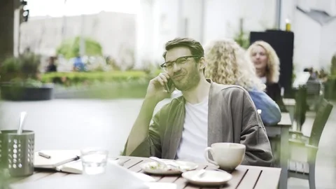 Hipster guy in a cafe on the phone Stock Footage 77488588