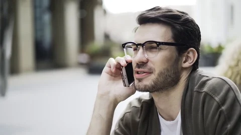 Hipster guy in a cafe on the phone, side view Stock Footage 77283508