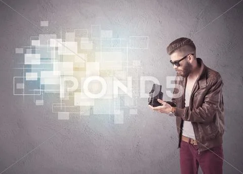 Hipster guy with retro camera in action Stock Photos