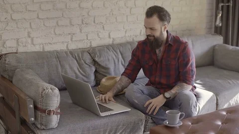Hipster guy spending time with his laptop Stock Footage 72517466