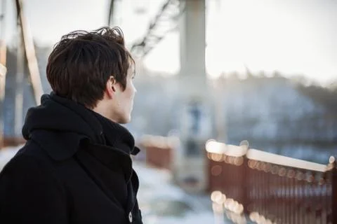 Hipster guy standing on the bridge looking away Stock Photos