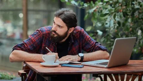 Hipster guy writing in a notebook. Foto stock