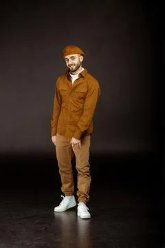 Hipster handsome model in beige hat smiling Stock Photos