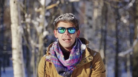 Hipster happy man throws snow up in winter Video stock 66782091