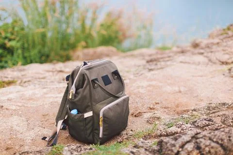 Hipster khaki backpack closeup  Front view tourist traveler bag on footpath b Stock Photos