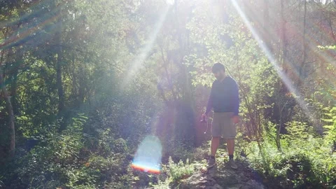 Hipster man with beard and backpack taking photos in nature Stock Footage 139611647