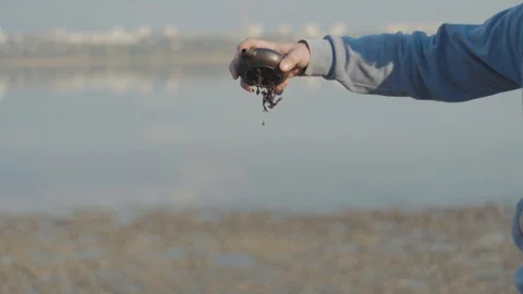 Hipster man with beard pulls leftover tea from clay pot. Handmade clay teapot Stock Footage 119336726