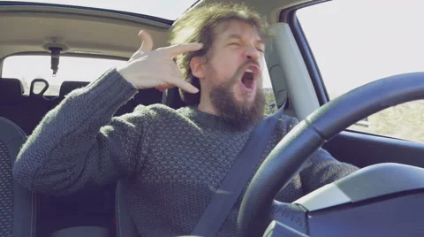 Hipster man with long beard and hair dancing rock music in car slow motion Stock Footage 66419420