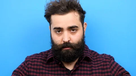 Hipster man with long beard puts his hat on Stock Footage 86436846