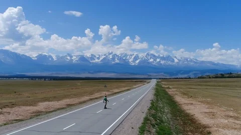 Hipster man longboarding extremely action in highway tropics in Asia aerial slow Stock Footage 77887514