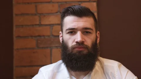 Hipster man looking at camera portrait smiling cafe bnackground - RED DRAGON Stock Footage 74007921