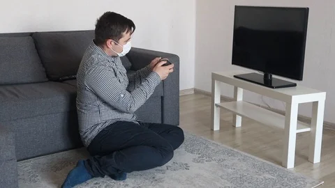 Hipster man playing with game console on tv Stock Footage 126734022