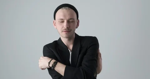 Hipster man posing in black blazer and knit hat Video stock 105189899