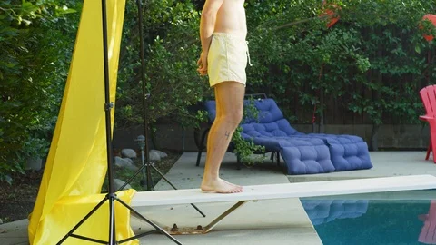 Hipster man sitting on the diving board Stock Footage 108943906