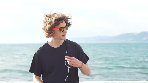 Hipster man sitting on longboard using his phone Stock Footage 97958037