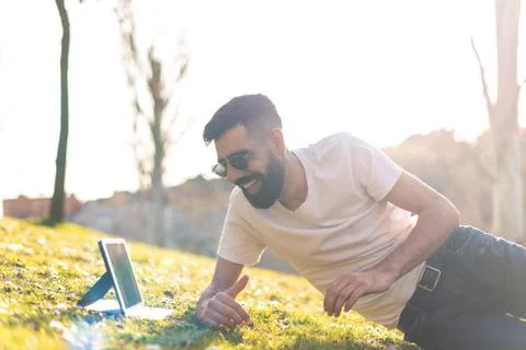 Hipster Man Using a digital Tablet in a Park. Stock Photos