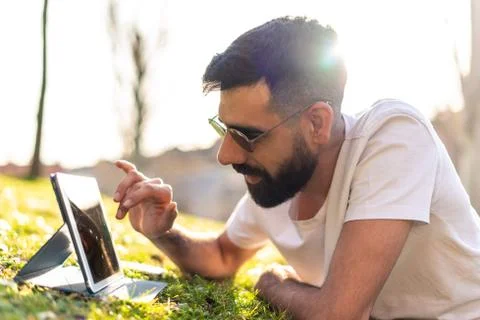 Hipster Man Using a digital Tablet in a Park. Stock Photos