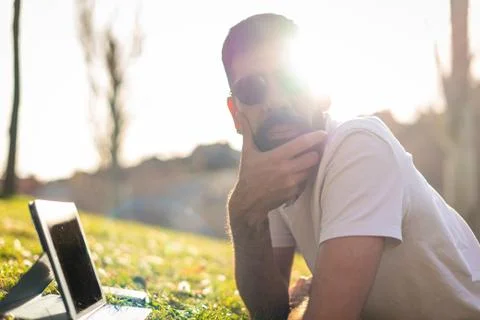 Hipster Man Using a digital Tablet in a Park. Stock Photos
