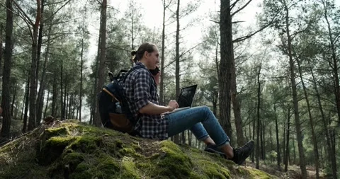 Hipster man working on laptop in forest during travel. Stock Footage 151844157