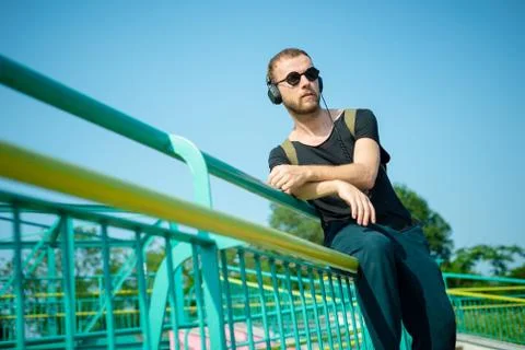 Hipster modern stylish blonde man listening music Stock Photos