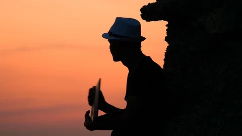 Hipster with notebook on sunset background. Freelancer working on the nature Stock-Footage 119847777