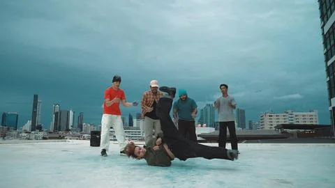 Hipster perform b-boy dance surround by multicultural dancer at city. Endeavor. Stock Photos