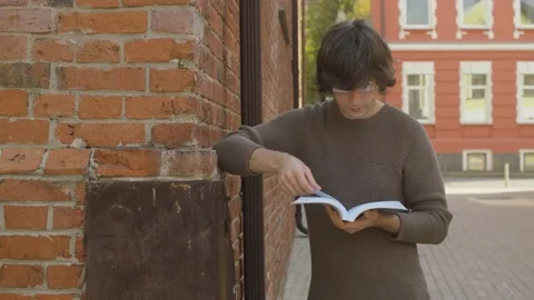 Hipster reading a book in the city Video stock 142455873