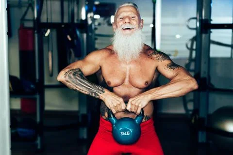 Hipster senior man training inside gym - Mature tattooed person having fun do Stock Photos