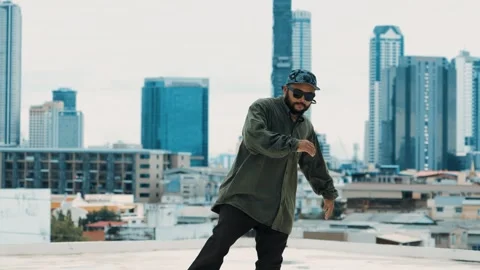Hipster show break dancing at rooftop with sky scrapper or city sites. hiphop. Stock Footage 257607502