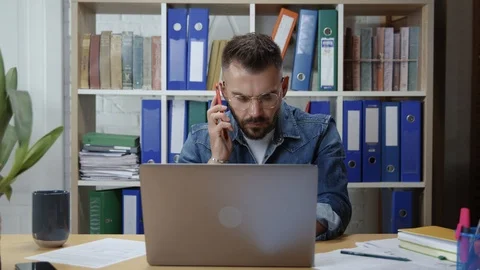 Hipster smart man engaged in work doing multi-tasking answering several calls Stock Footage 118222766