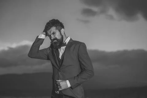 Hipster with stylish appearance in front of dramatic sky, skyline. Фото