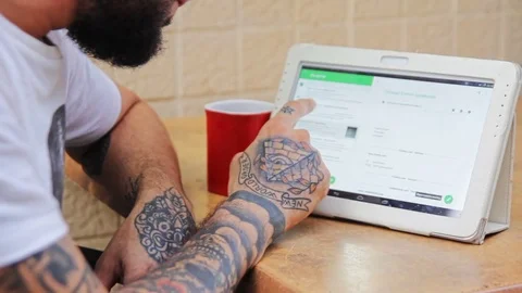 Hipster surfing in the web on tablet Stock Footage 70861818