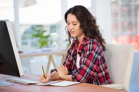 Hipster taking notes in a notebook 写真素材