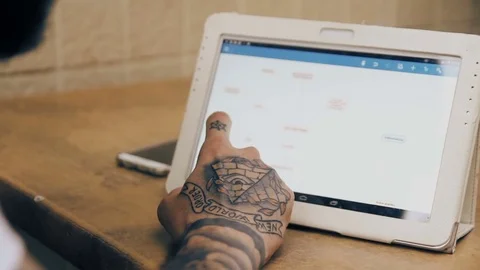 Hipster with tattoos using tablet Stock Footage 70861733