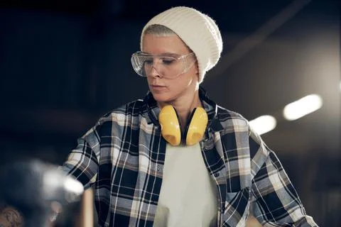 Hipster woman in 40s working at workshop Stock Photos