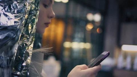 Hipster woman using app on smartphone in beauty salon while dyeing her hair Stock Footage 86697313