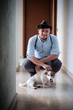 Hipster young man posing with jack russell dog Stock Photos
