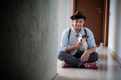 Hipster young man posing with jack russell dog Stock Photos
