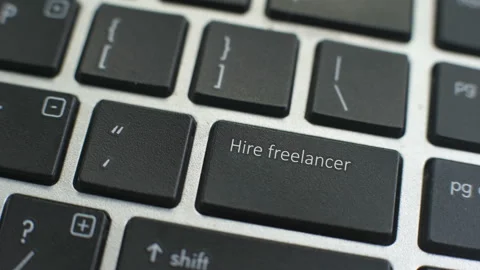 Hire Freelancer button on computer keyboard, female hand fingers press key Stock Footage 97825866