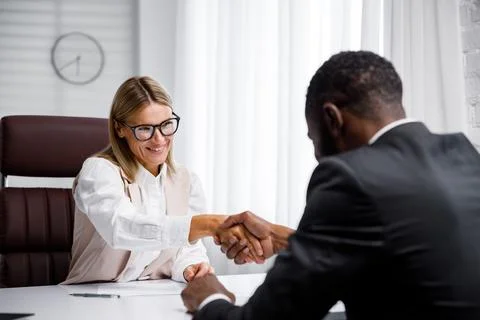 Hiring, interview. Middle-aged blond business woman conducting an interview in a Stock Photos
