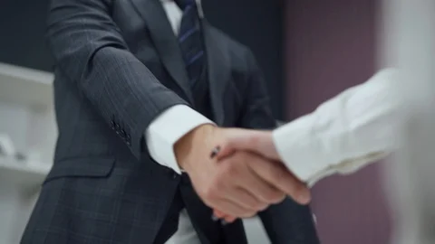 Hiring, man in a suit, a businessman shaking hands with a woman colleague Stock Footage
