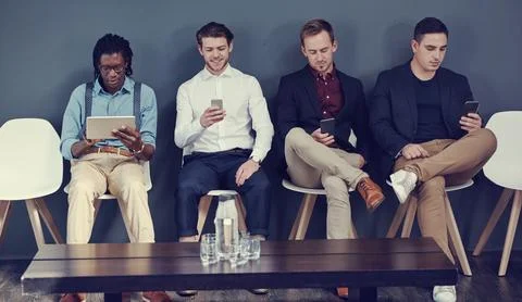 Hiring, row or men with tech in waiting room for job opportunity, online CV.. Foto stock