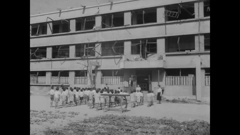 Hiroshima 1940s: Bomb-damaged multi-story concrete building with blown-out Stock Footage 341987674