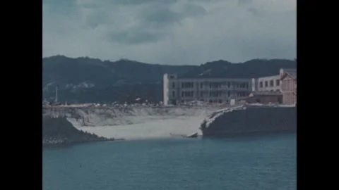 Hiroshima 1940s: Devastated waterfront landscape across a river shows destroyed Stock-Footage 344140055