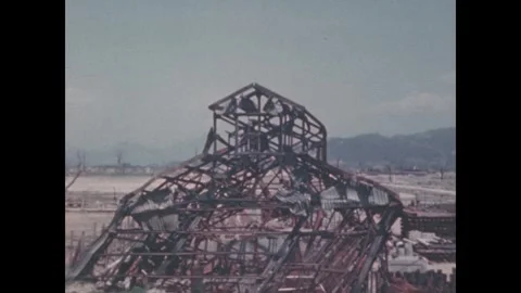 Hiroshima 1940s: Skeletal steel framework of a bombed building stands twisted Stock Footage 344140457