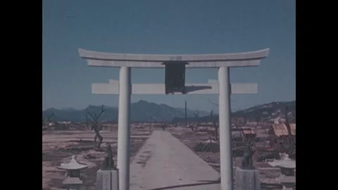 Hiroshima 1940s: White torii gate stands intact along a road amid the flattened Video stock 344140353