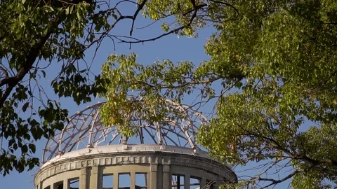 Hiroshima Atomic Bomb Memorial Dome Ruins, Downward Tilt Reveal On Clear Stock Footage 100587921