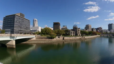 Hiroshima Castle moat reflecting the surrounding modern city buildings Stock Footage 335544611